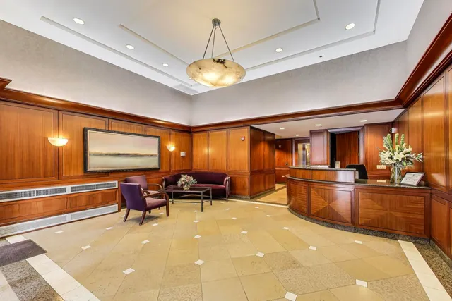 a lobby with furniture and chandelier