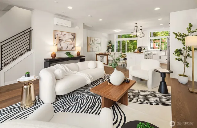 a living room with furniture a rug and kitchen view