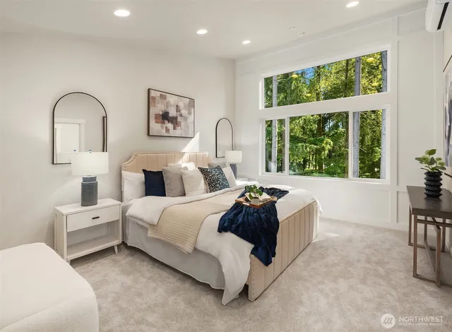 a spacious bedroom with bed and a large window