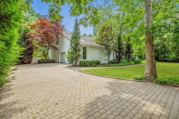 a view of backyard of house with green space