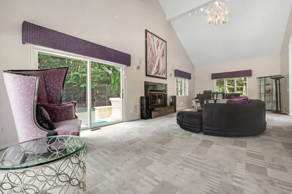 a living room with furniture and a floor to ceiling window