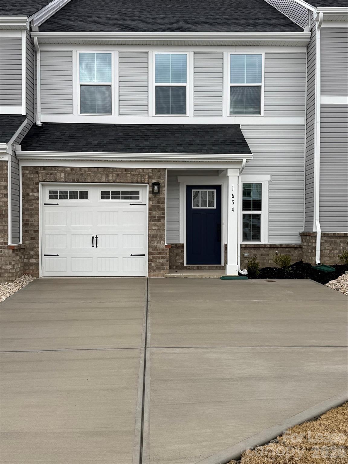 1654 Respect Street Northwest Concord, NC 28027 - Photo 2 of 19 a view of a house with a parking space
