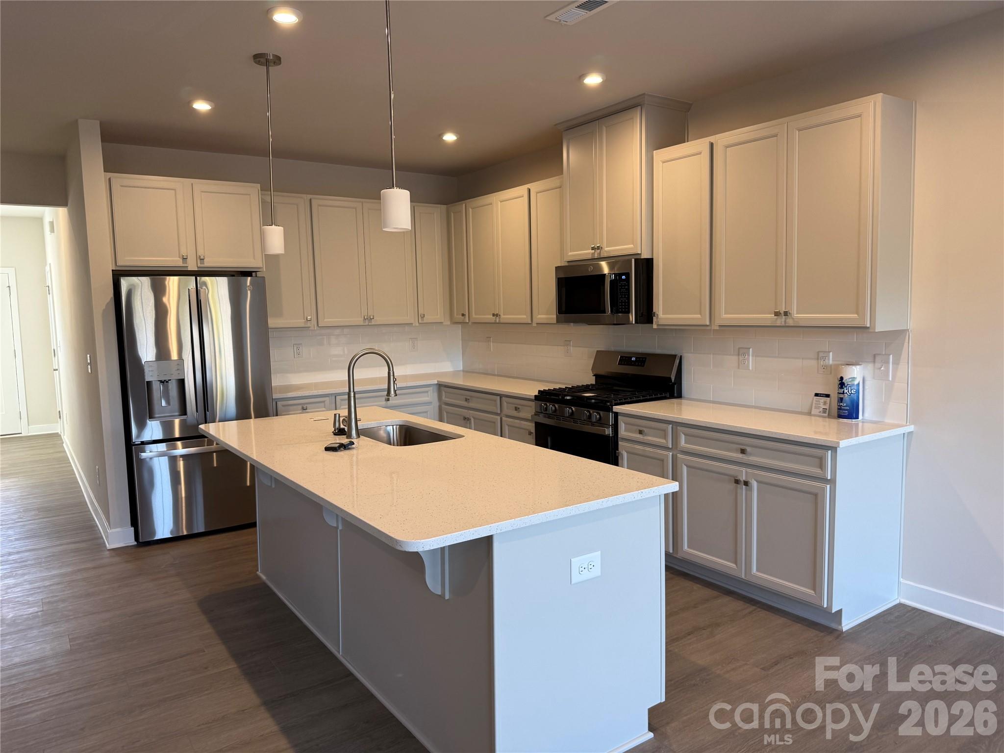1654 Respect Street Northwest Concord, NC 28027 - Photo 6 of 19 a kitchen with stainless steel appliances a sink stove refrigerator and cabinets