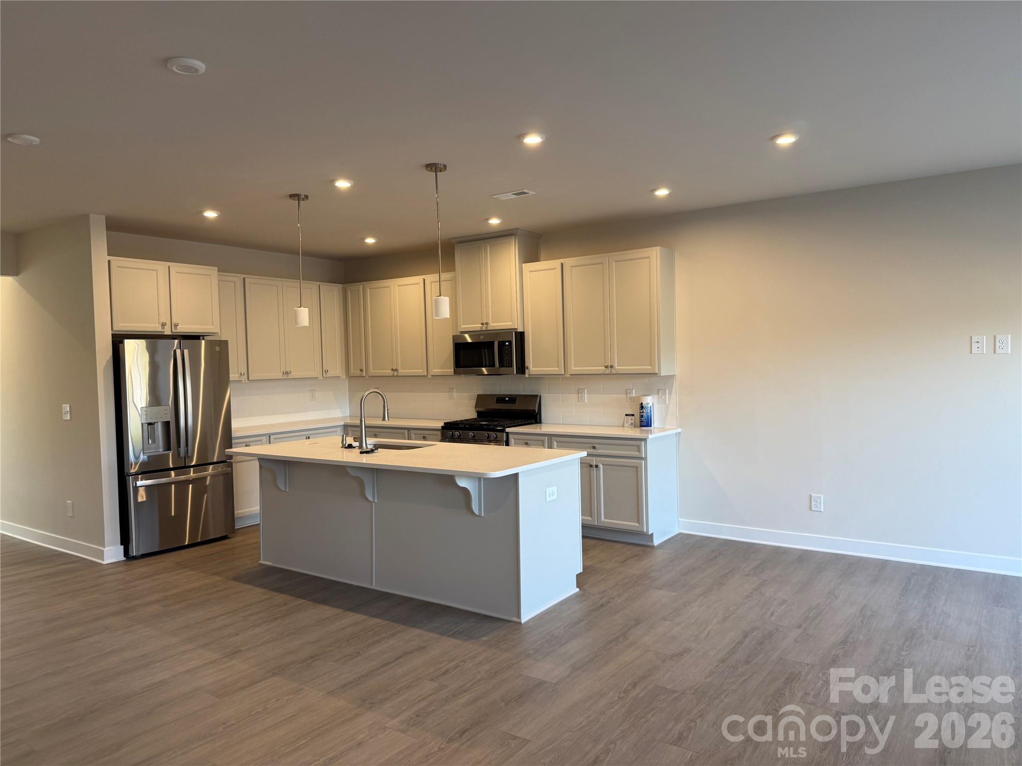 1654 Respect Street Northwest Concord, NC 28027 - Photo 7 of 19 a kitchen with stainless steel appliances granite countertop a stove a refrigerator a sink and a oven