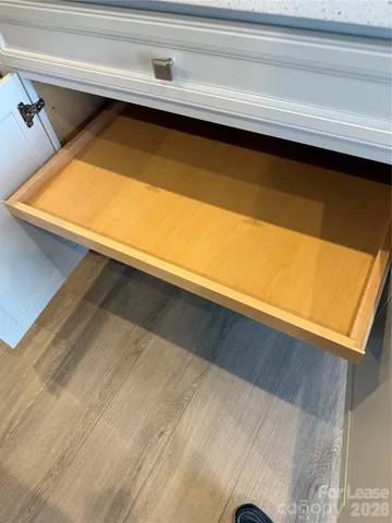 a view of a hallway with wooden shelves