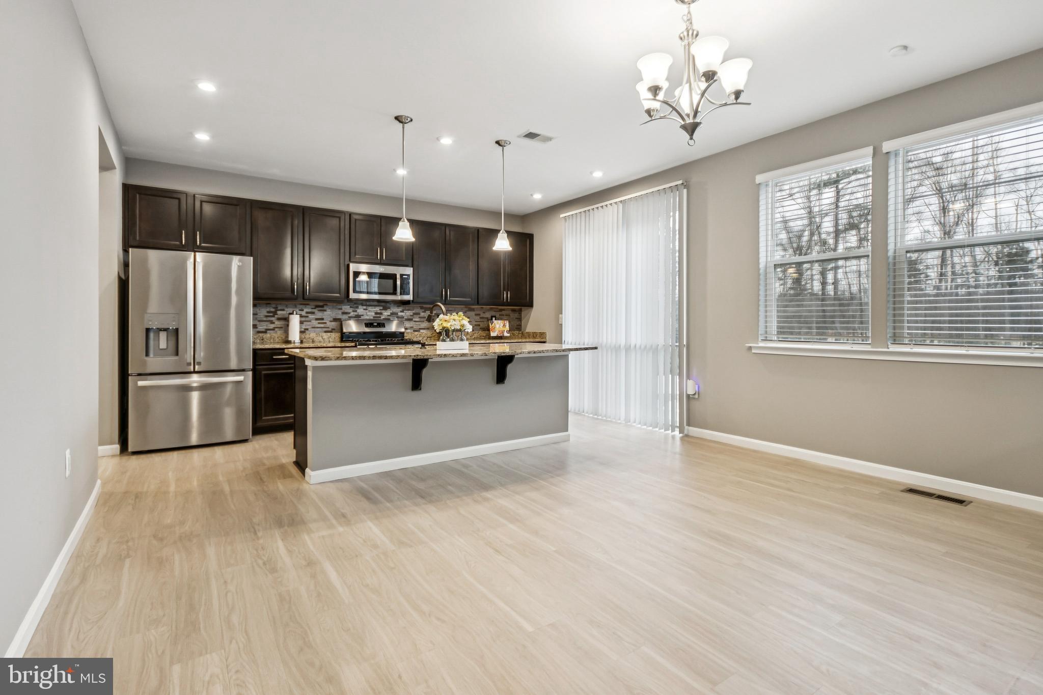 7252 Liberty Court Ruther Glen, VA 22546 - Photo 11 of 45 a kitchen with kitchen island a sink stainless steel appliances and counter space