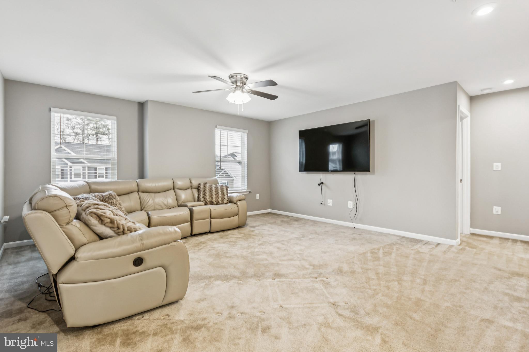 7252 Liberty Court Ruther Glen, VA 22546 - Photo 20 of 45 a living room with furniture and a flat screen tv