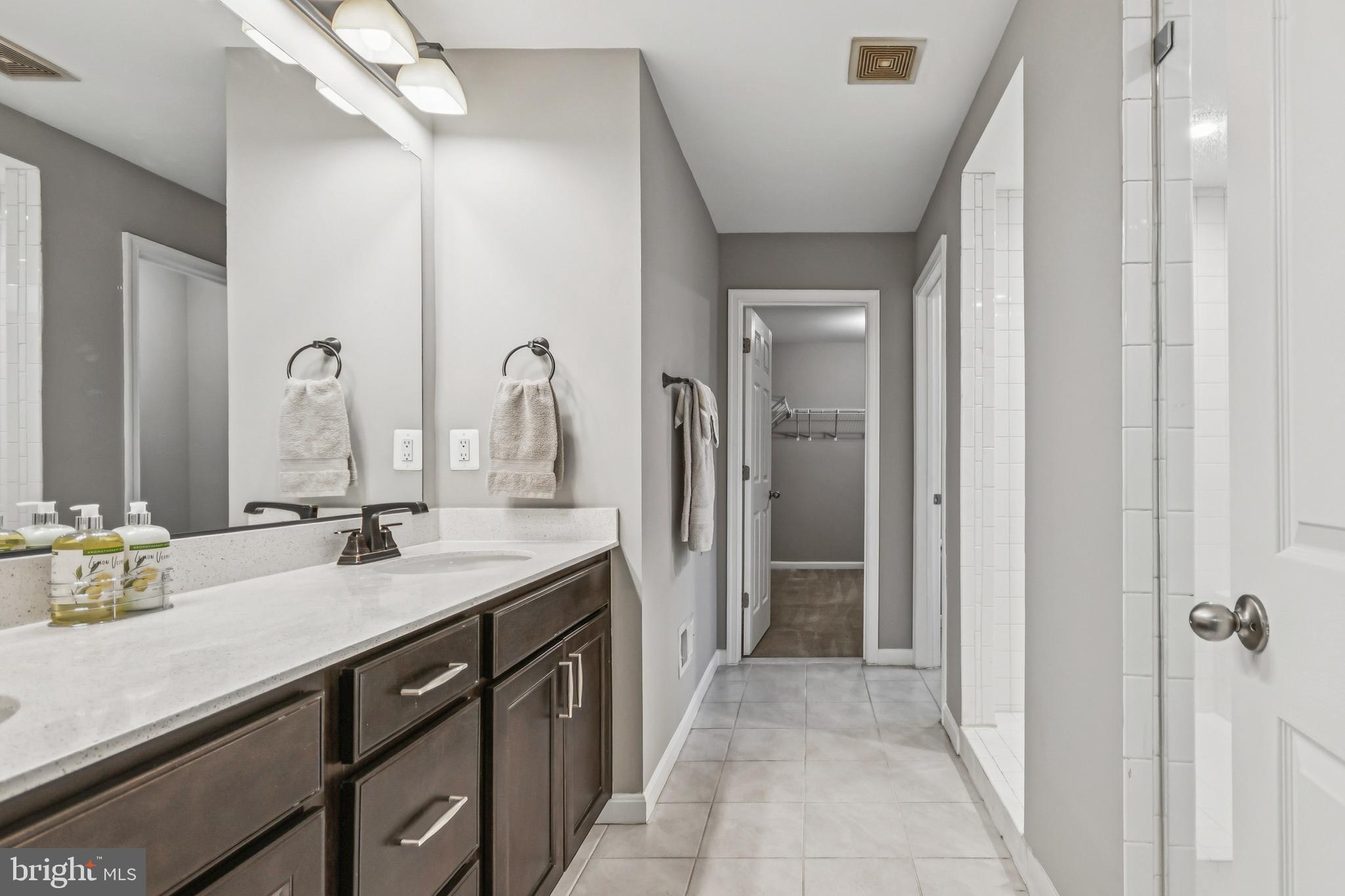 7252 Liberty Court Ruther Glen, VA 22546 - Photo 31 of 45 a bathroom with a double vanity sink and a mirror
