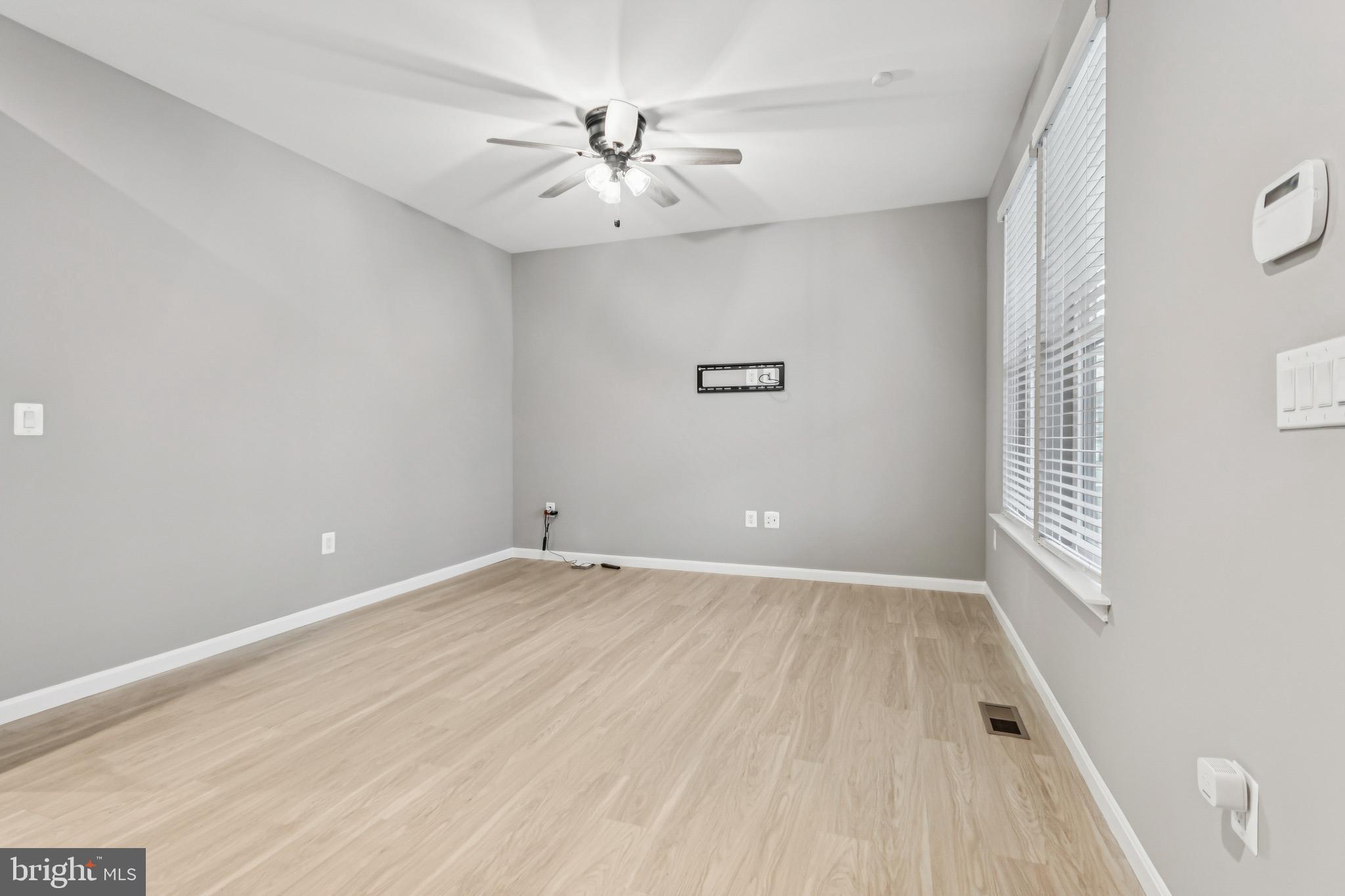 7252 Liberty Court Ruther Glen, VA 22546 - Photo 6 of 45 wooden floor in an empty room with a window