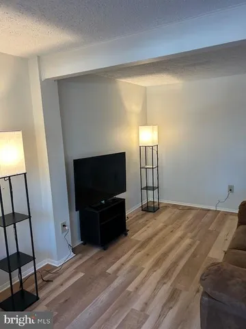 a view of a livingroom with furniture and a flat screen tv