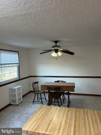 a view of a room with furniture and wooden floor