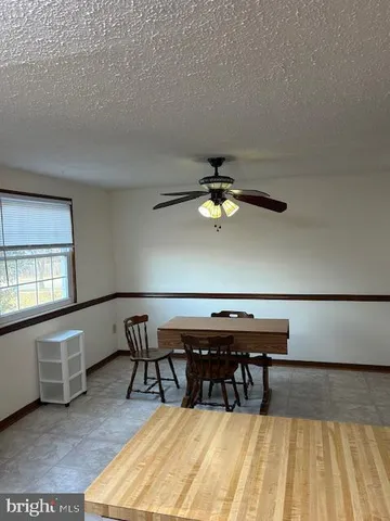 a view of a room with furniture and wooden floor