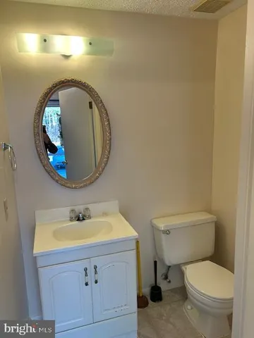 a bathroom with a sink mirror and toilet
