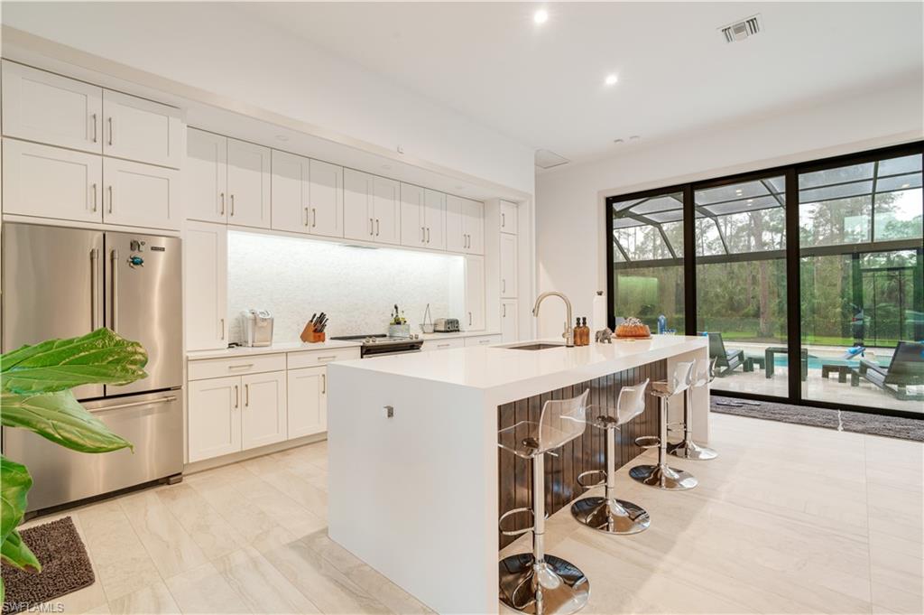 2991 2nd Street Northwest Naples, FL 34120 - Photo 11 of 43 a large white kitchen with a large window