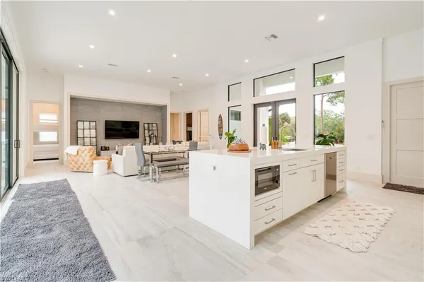 a kitchen with cabinets and wooden floor