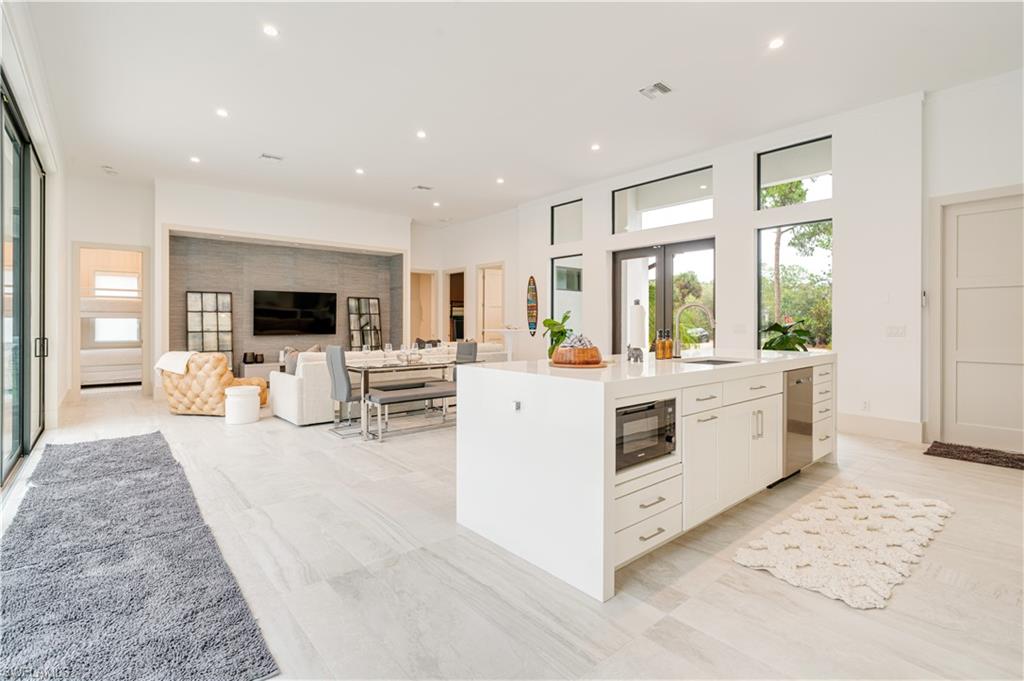 2991 2nd Street Northwest Naples, FL 34120 - Photo 14 of 43 a kitchen with cabinets and wooden floor