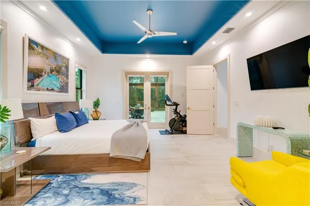 a spacious bedroom with a large bed and a flat screen tv