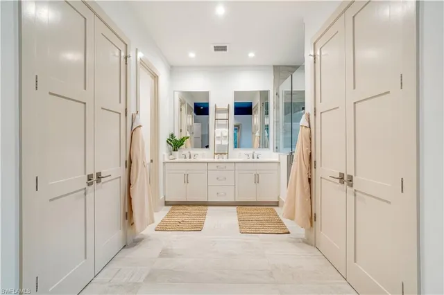 a bathroom with a tub sink shower and mirror