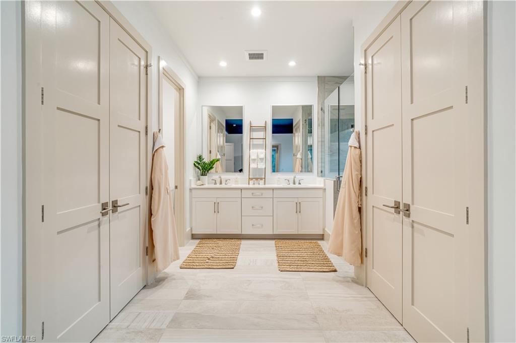 2991 2nd Street Northwest Naples, FL 34120 - Photo 19 of 43 a bathroom with a tub sink shower and mirror