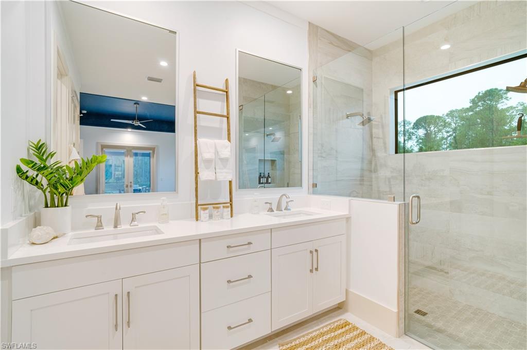 2991 2nd Street Northwest Naples, FL 34120 - Photo 21 of 43 a bathroom with a double vanity sink mirror and shower