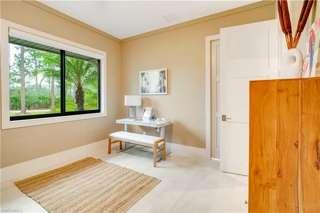 a living room with a bed and a window