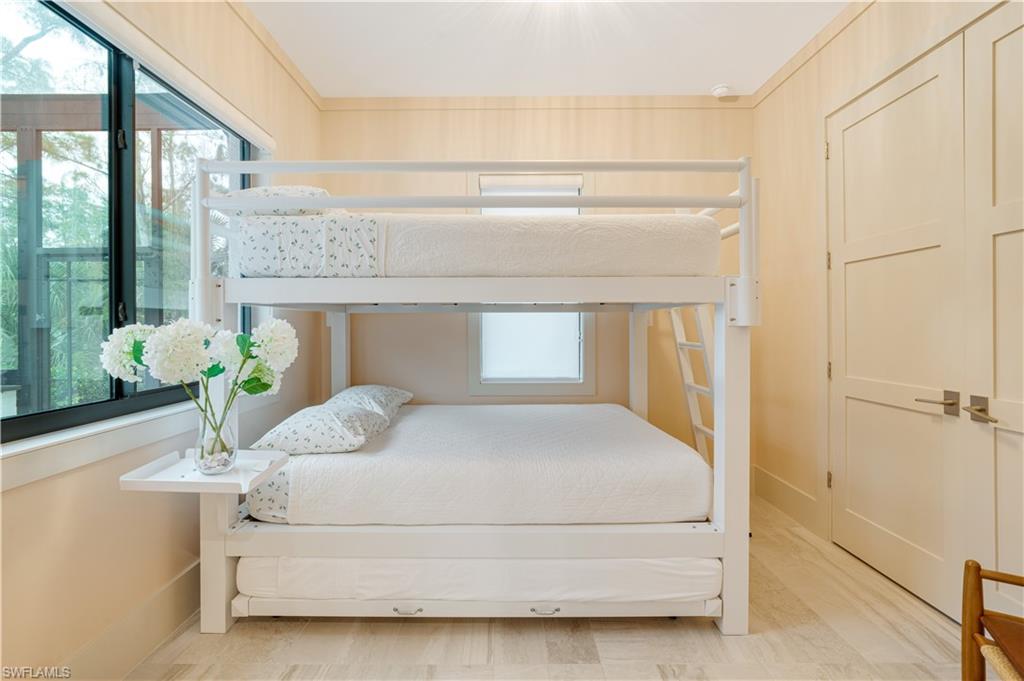 2991 2nd Street Northwest Naples, FL 34120 - Photo 26 of 43 a bedroom with a bed potted plant on the dresser and floor