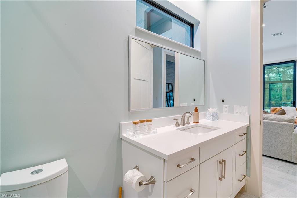 2991 2nd Street Northwest Naples, FL 34120 - Photo 29 of 43 a bathroom with a sink and a mirror