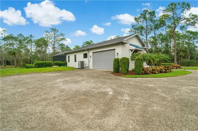a view of a house with a yard and garage