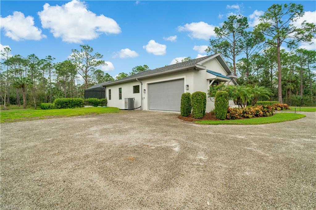 2991 2nd Street Northwest Naples, FL 34120 - Photo 31 of 43 a view of a house with a yard and garage