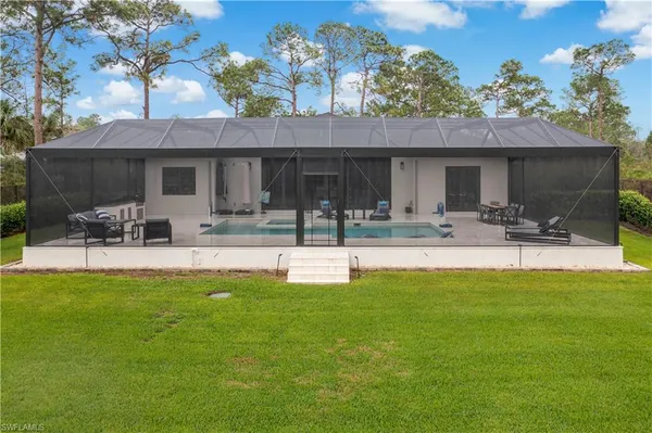 a view of a house with a backyard porch and sitting area