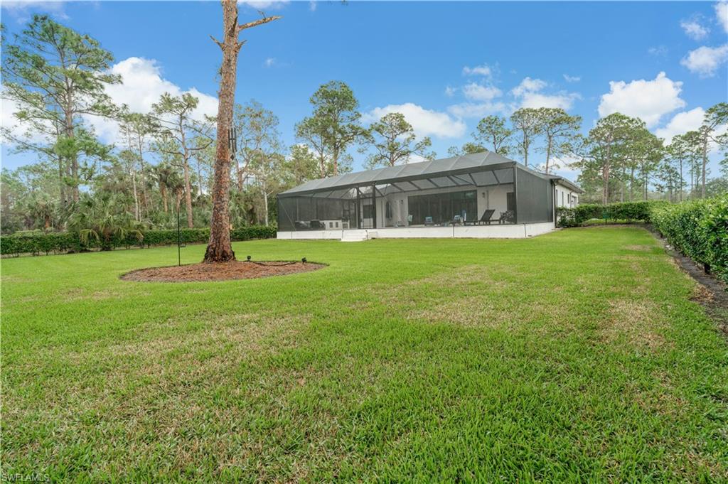 2991 2nd Street Northwest Naples, FL 34120 - Photo 34 of 43 a front view of a house with a yard