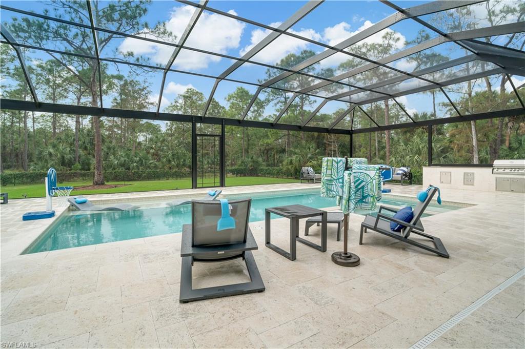 2991 2nd Street Northwest Naples, FL 34120 - Photo 37 of 43 a view of a swimming pool with a lounge chair