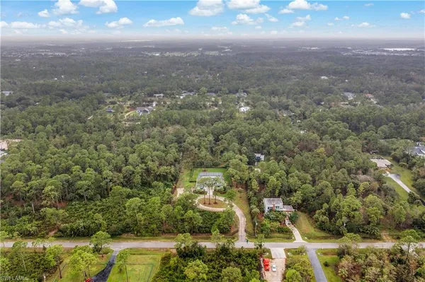 an aerial view of a house with yard