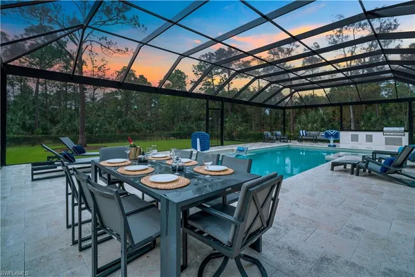 a view of an outdoor sitting area with furniture and umbrella