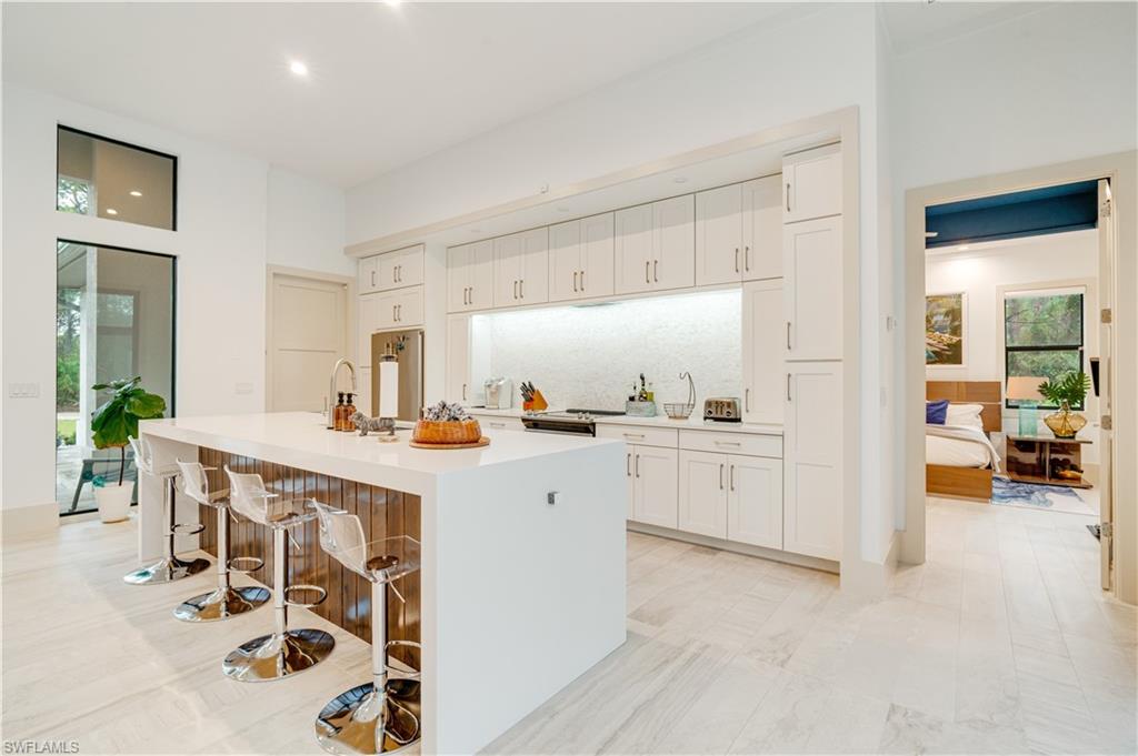 2991 2nd Street Northwest Naples, FL 34120 - Photo 10 of 43 a kitchen with a sink and chairs