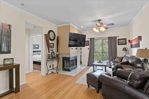 a living room with furniture a flat screen tv and a fireplace