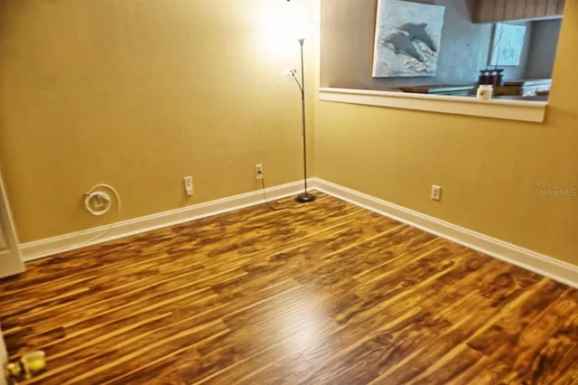 a view of a room with wooden floor