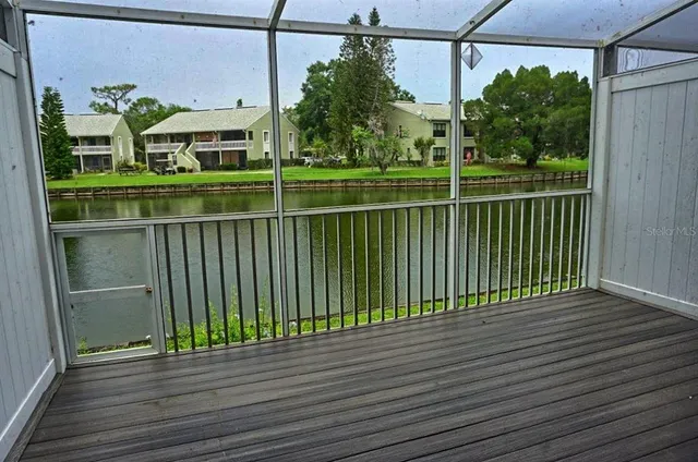 a view of a brick house with a big yard