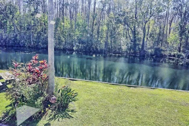 a view of a lake with a house in background
