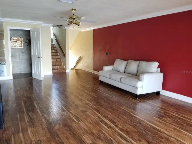 a living room with furniture and wooden floor
