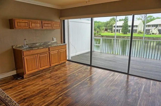 a view of a room with wooden floor and outdoor view