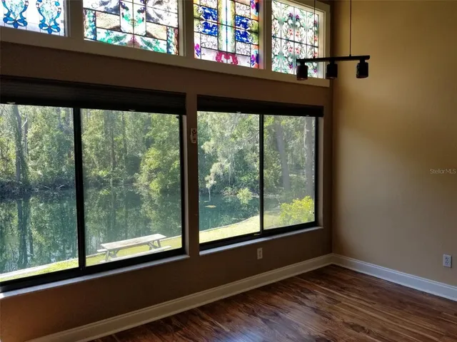 a view of a black and white house with a porch
