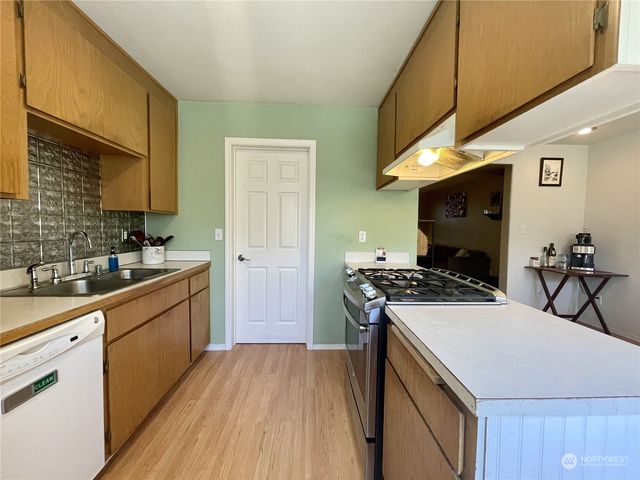 a kitchen with a stove and a sink