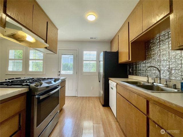a kitchen with a stove and a sink