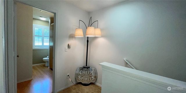 a spacious bedroom with a bed and a flat screen tv