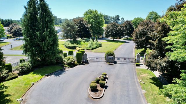 a view of a swimming pool with a patio and a yard