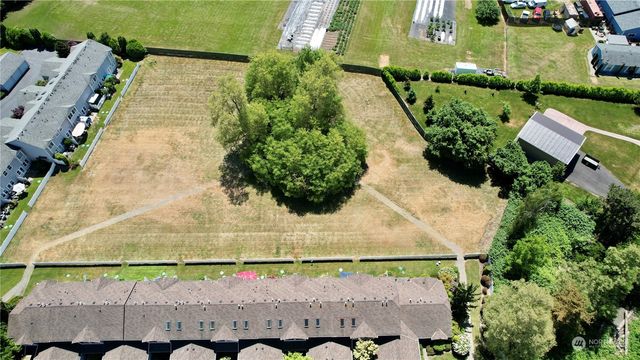 an aerial view of lake residential house with swimming pool and green space