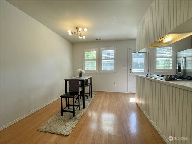 a view of a livingroom with furniture window and wooden floor