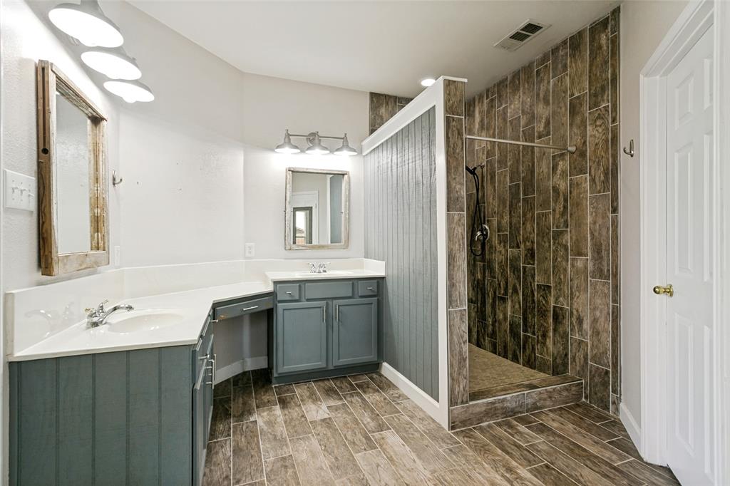 4107 Waverly Road Corinth, TX 76208 - Photo 15 of 30 The primary bath was upgraded in 2020 with a shower remodel and ceramic tile flooring and wall tile.