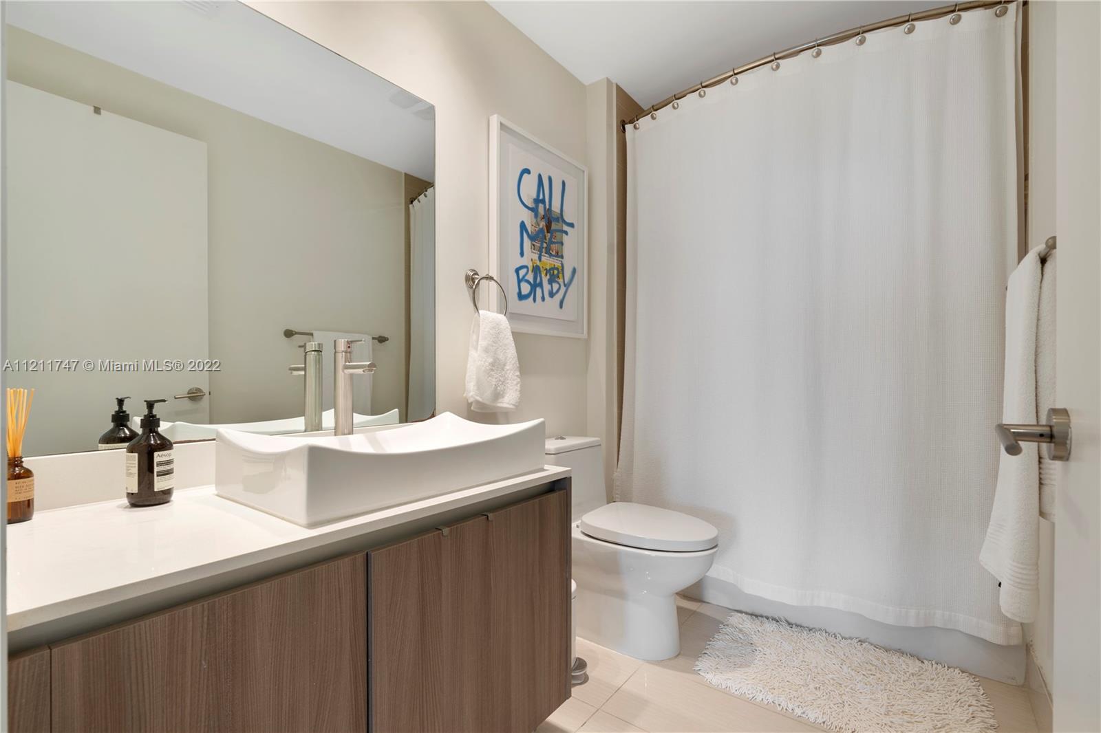 201 Southwest 17th Road, Unit 501 Miami, FL 33129 - Photo 16 of 21 a bathroom with a sink a toilet and shower